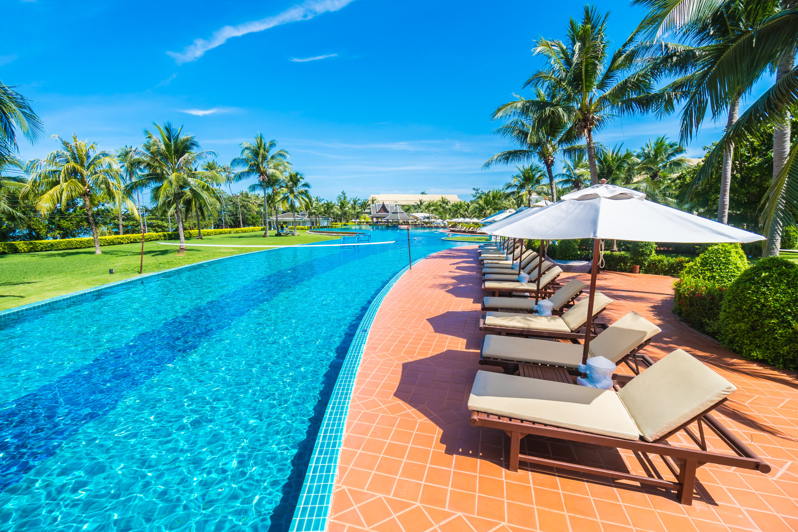umbrella and chair around swimming pool